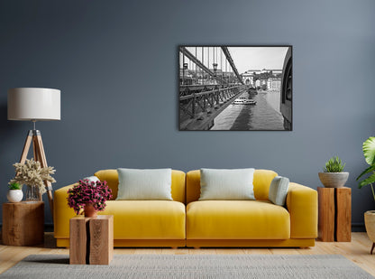 The Széchenyi Chain Bridge, Budapest. B&W, black and white with black frame, giclee canvas print in situ on a grey wall with a yellow sofa and wooden tones.
David Kitching KitchingArt