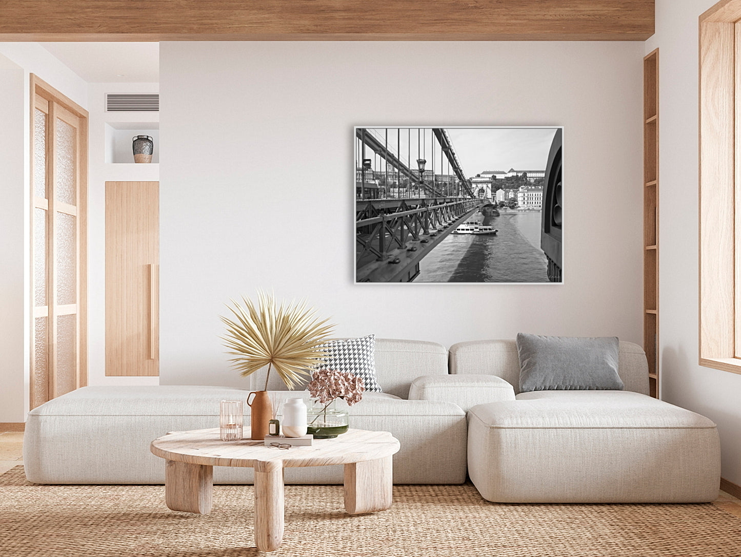 The Széchenyi Chain Bridge, Budapest. B&W, black and white with white frame, giclee canvas print in situ on a white wall with a white sofa and wooden tones.
David Kitching KitchingArt